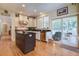 Bright kitchen with island and bar seating that opens to the rear screened deck at 8657 Refuge Point Circle Cir, Charleston, SC 29420