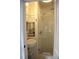 Modern bathroom features a glass enclosed shower, sink and shelves with fresh white towels at 9 West St # 1, Charleston, SC 29401