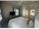 Bright bedroom with a ceiling fan, tv, a dresser and large bed with decorative pillows at 9 West St # 1, Charleston, SC 29401