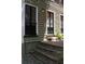 Charming exterior with sage green siding, dark trim, and a brick stairway entrance at 9 West St # 1, Charleston, SC 29401
