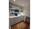 Compact kitchen featuring modern appliances, white cabinets, a microwave, and a beverage cooler at 9 West St # 1, Charleston, SC 29401