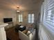 Inviting living area with white armchairs, a dark blue ottoman, hardwood floors, and natural light at 9 West St # 1, Charleston, SC 29401