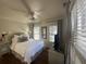 Bright main bedroom with hardwood floors, ceiling fan, dresser, and large windows with wooden blinds at 9 West St # 1, Charleston, SC 29401