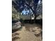 Gravel parking area features a grey SUV, wooden fence and beautiful trees at 9 West St # 1, Charleston, SC 29401