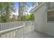 Exterior view of a home featuring a wooden fence, greenery and stairs to a deck at 987 Harbor Oaks Dr, Charleston, SC 29412