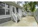 Backyard patio with stairs leading to the back of the house with green trees in the background at 987 Harbor Oaks Dr, Charleston, SC 29412