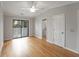 Bedroom featuring hardwood floors, ceiling fan, and a door to the bathroom at 987 Harbor Oaks Dr, Charleston, SC 29412