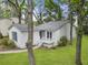 Stylish single-story home with a cozy front porch, well-maintained lawn, and lovely trees at 987 Harbor Oaks Dr, Charleston, SC 29412