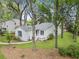 Charming single story home with white facade, mature trees, and a welcoming front porch at 987 Harbor Oaks Dr, Charleston, SC 29412