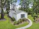 Back exterior of a home with beautiful trees, garden, and a sidewalk at 987 Harbor Oaks Dr, Charleston, SC 29412