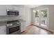 Bright kitchen with stainless steel range and access to a covered outdoor deck at 987 Harbor Oaks Dr, Charleston, SC 29412