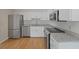 Modern kitchen featuring stainless steel appliances, granite countertops, and white cabinets and hardwood floors at 987 Harbor Oaks Dr, Charleston, SC 29412