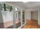 An interior courtyard is visible through the glass of the living area with beautiful hardwood floors at 987 Harbor Oaks Dr, Charleston, SC 29412