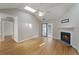 Spacious living room features a cozy fireplace, skylight, ceiling fan, and access to the patio at 987 Harbor Oaks Dr, Charleston, SC 29412