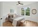 Bright bedroom features a ceiling fan, hardwood floors, and a window view of the outdoors at 1014 E Erie Ave, Folly Beach, SC 29439