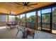 Covered outdoor deck featuring wood ceiling, ceiling fans, comfortable seating, and tranquil views at 1014 E Erie Ave, Folly Beach, SC 29439