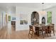 Elegant dining room with hardwood floors, stylish seating, and a view into the modern kitchen at 1014 E Erie Ave, Folly Beach, SC 29439