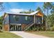 Stunning exterior view of a modern home featuring a metal roof, wooden accents, and lush landscaping at 1014 E Erie Ave, Folly Beach, SC 29439
