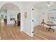 Bright hallway leading to an office and dining area, showcasing hardwood floors and an arched doorway at 1014 E Erie Ave, Folly Beach, SC 29439