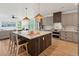 Bright kitchen boasts large island with seating, stainless appliances, and stylish pendant lighting at 1014 E Erie Ave, Folly Beach, SC 29439