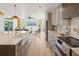 Open kitchen with a large island, stainless steel appliances, and seamless flow into the living area at 1014 E Erie Ave, Folly Beach, SC 29439