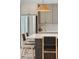 Stylish kitchen island with seating, stainless steel refrigerator, and modern pendant lighting at 1014 E Erie Ave, Folly Beach, SC 29439