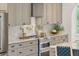 Kitchen featuring stone countertops, stainless steel appliances, stylish cabinets, and a tiled backsplash at 1014 E Erie Ave, Folly Beach, SC 29439