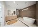 Sleek main bathroom features a double vanity, a glass-enclosed shower, and a soaking tub at 1014 E Erie Ave, Folly Beach, SC 29439