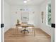 Bright home office with a stylish desk, chair, and a large window offering natural light at 1014 E Erie Ave, Folly Beach, SC 29439