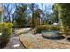 Relaxing backyard featuring a stock tank pool surrounded by lush greenery at 103 Tall Oak Ave, Charleston, SC 29407