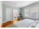 A calming bedroom with hardwood floors, natural light, and a view into an ensuite bathroom at 103 Tall Oak Ave, Charleston, SC 29407