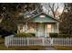 Charming green home with a white picket fence and beautifully landscaped front yard at 103 Tall Oak Ave, Charleston, SC 29407