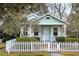 Charming turquoise home with a white picket fence and beautifully landscaped front yard at 103 Tall Oak Ave, Charleston, SC 29407