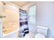 Bright bathroom featuring shower with shower curtain, toilet and window at 106 Trimley Ct, Goose Creek, SC 29445