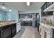 Modern kitchen features stainless steel appliances, dark cabinets, and granite countertops at 106 Trimley Ct, Goose Creek, SC 29445