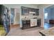 Well-lit kitchen featuring dark cabinetry, tiled floors, and granite countertops, creating a modern culinary space at 106 Trimley Ct, Goose Creek, SC 29445