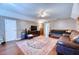 Well-lit living room with hardwood floors, patterned wallpaper, and comfortable seating at 106 Trimley Ct, Goose Creek, SC 29445