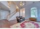 Expansive living room showcasing vaulted ceilings, hardwood floors, staircase and large windows at 106 Trimley Ct, Goose Creek, SC 29445