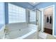 Luxurious main bathroom featuring a large soaking tub and walk-in shower, offering a spa-like experience at 106 Trimley Ct, Goose Creek, SC 29445