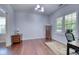 Well-lit office area featuring hardwood floors, two windows, and a neutral color palette at 106 Trimley Ct, Goose Creek, SC 29445