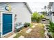 Backyard featuring a blue door and a decorative sun accent and walkway stones with bushes at 107 Clear Bend Ln, Summerville, SC 29486