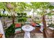 Relaxing backyard patio setting with string lights, hanging plants, a hammock, and a wooden privacy fence at 107 Clear Bend Ln, Summerville, SC 29486