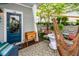 Quaint outdoor space with a cozy hammock, a patio rug, and a charming blue door entryway at 107 Clear Bend Ln, Summerville, SC 29486
