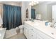 Bathroom featuring a double sink vanity, large mirror, neutral walls and a shower with blue curtain at 107 Clear Bend Ln, Summerville, SC 29486