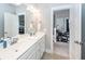 Bright bathroom featuring a double vanity, modern lighting, and a view into an adjacent office at 107 Clear Bend Ln, Summerville, SC 29486