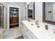 Bright bathroom featuring a dual sink vanity and access to walk-in closet at 107 Clear Bend Ln, Summerville, SC 29486