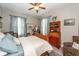 A well-lit primary bedroom offers a tranquil setting with a decorative hutch and a large bed at 107 Clear Bend Ln, Summerville, SC 29486