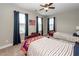 Cozy bedroom with two twin beds, dark blue curtains, and ceiling fan, perfect for restful nights at 107 Clear Bend Ln, Summerville, SC 29486