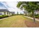 Scenic view of a well-manicured green space lined with charming homes and lush landscaping at 107 Clear Bend Ln, Summerville, SC 29486