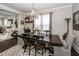 A dining room features a chandelier, wooden table, and area rug at 107 Clear Bend Ln, Summerville, SC 29486